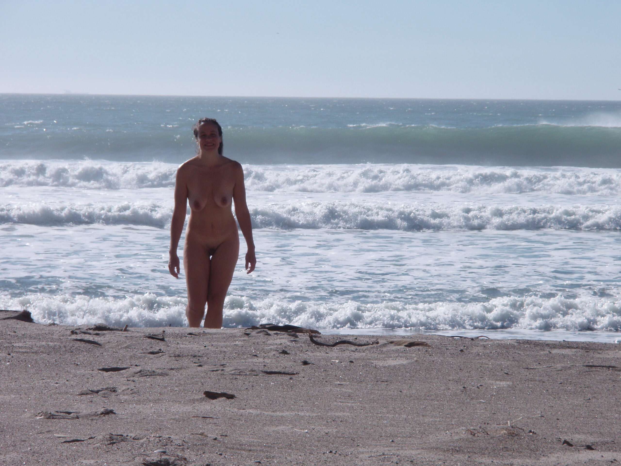 Walking naked on a nude beach after a swim